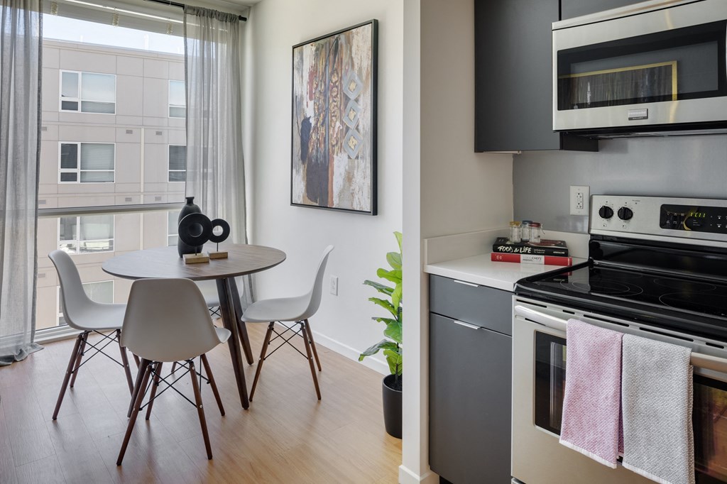 a kitchen and dining area with a table and chairs
